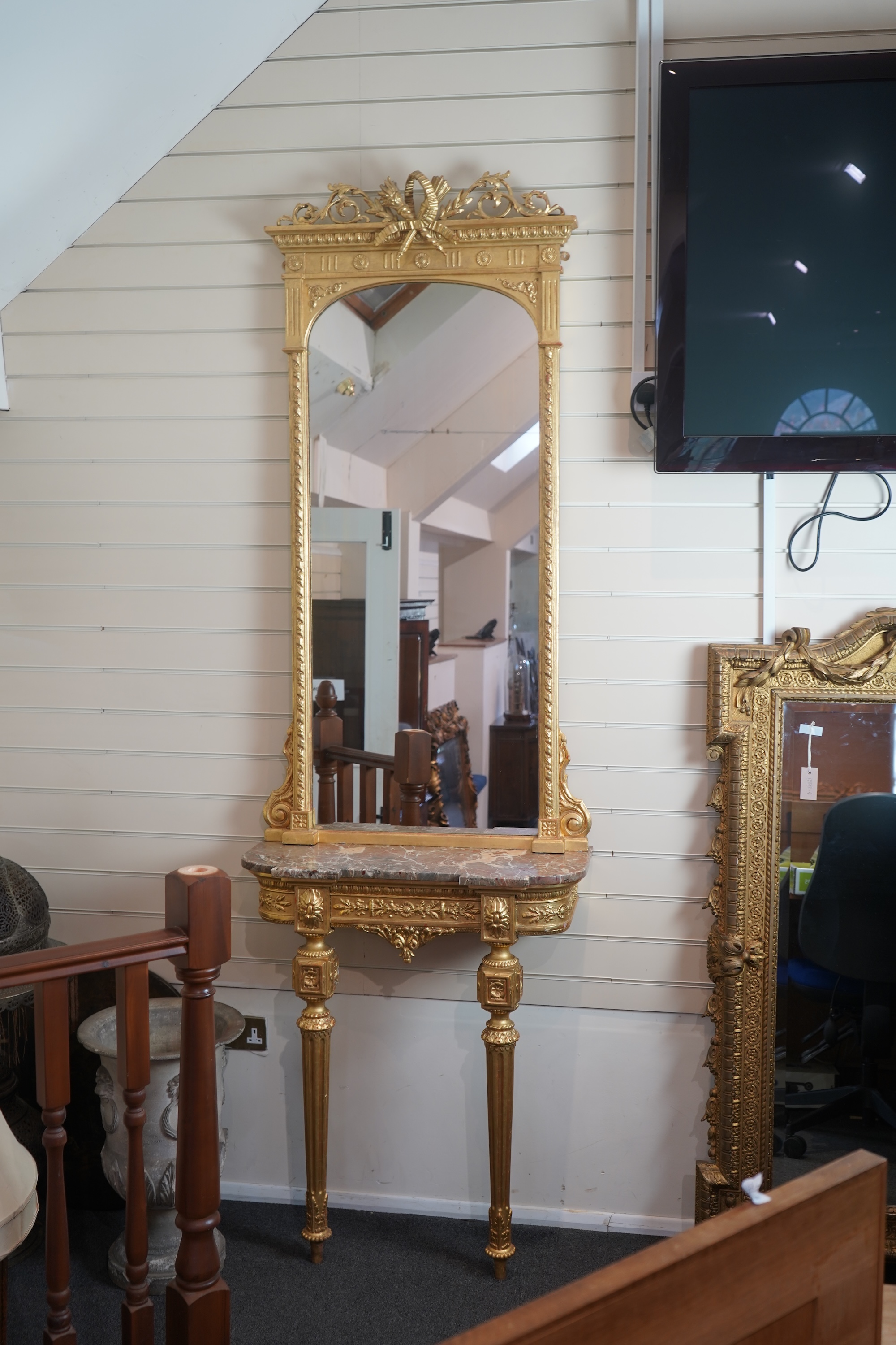 A pair of Louis XVI style giltwood and composition marble topped pier tables and mirrors